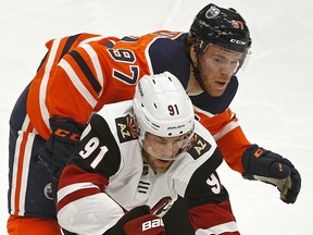 Arizona Coyotes Taylor Hall (front) is checked by Edmonton Oilers captain Connor McDavid during NHL hockey game action in Edmonton on Saturday January 18, 2020. (PHOTO BY LARRY WONG/POSTMEDIA)