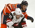 Arizona Coyotes Taylor Hall (front) is checked by Edmonton Oilers captain Connor McDavid during NHL hockey game action in Edmonton on Saturday January 18, 2020. (PHOTO BY LARRY WONG/POSTMEDIA)