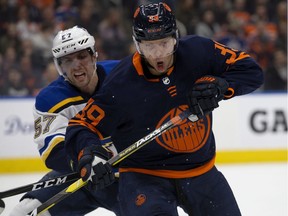 The Edmonton Oilers' Alex Chiasson (39) battles the St. Louis Blues' David Perron (57) at Rogers Place on Friday, Jan. 31, 2020.