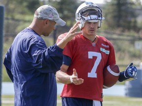 Former Toronto Argonauts head coach Scott Milanovich talks with quarterback Trevor Harris at Downsview Park during practice in Toronto in this file photo from Sept. 24, 2015. The pair has been reunited on the Edmonton Eskimos.