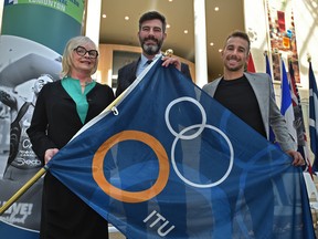 Posing with the ITU flag, from left Sheila O'Kelly, World Triathlon Edmonton president, Mayor Don Iveson and Tyler Mislawchuk, Canadian triathlete, at the 2020 ITU Triathlon Grand Final official kicked-off, for this upcoming summer August 17-23, at City Hall in Edmonton, Jan. 27, 2020.