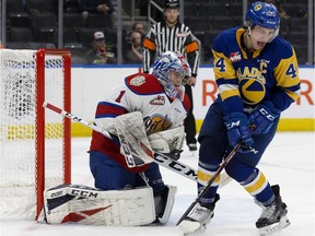 The Edmonton Oil Kings' goaltender Beck Warm (1) battles the Saskatoon Blades' Chase Wouters (44) during second period WHL action at Rogers Place, in Edmonton Sunday Jan. 5, 2020.