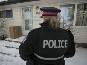 Const. Carly Perreaux looks at a home with mail piling up and unshoveled walkways, during a press conference where she spoke to the media about winter home protection and the prevention of break-and-enters, in Edmonton Thursday Jan. 23, 2020. David Bloom / Postmedia
