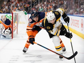 Leon Draisaitl (29) of the Edmonton Oilers chases Patrice Bergeron (37) of the Boston Bruins at Rogers Place on Oct. 18, 2018.