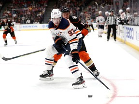 Ryan Getzlaf (15) of the Anaheim Ducks defends against Ryan Nugent-Hopkins (93) of the Edmonton Oilers at Honda Center on Nov. 10, 2019, in Anaheim, Calif.