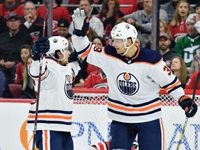 Kailer Yamamoto, left, celebrates with teammate Alex Chiasson of the Edmonton Oilers after scoring a goal against the Carolina Hurricanes during the second period of their game at PNC Arena on February 16, 2020 in Raleigh, North Carolina.