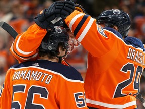 Edmonton Oilers forward Ryan Nugent-Hopkins (93) celebrates a goal with Leon Draisaitl (29) and Kailer Yamamoto (56) on Nashville Predators' goaltender Pekka Rinne at Rogers Place on Jan. 14, 2020.