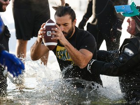 Edmonton Eskimos wide receiver Diego Jair Viamontes Cotera jumps in during the 2020 Polar Plunge at Lake Summerside on Jan. 26, 2020, in support of the Law Enforcement Torch Run (LETR) for Special Olympics Alberta.