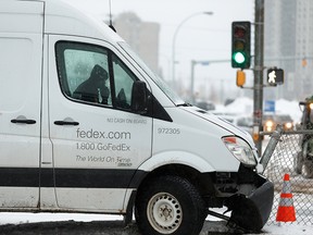 A FedEx truck struck a fence in the middle of 112 Avenue at Stadium Road in Edmonton, on Tuesday, Feb. 11, 2020. Slippery conditions and snowfall created difficult driving conditions across much of the city.