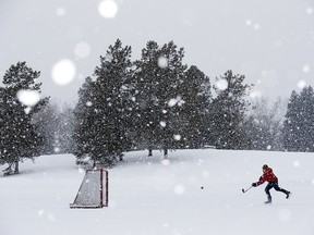 Andre Lessard plays hockey as a heavy snow falls in Edmonton's Hawrelak Park Thursday Feb. 9, 2020. Photo by David Bloom