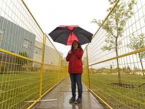 Andrea Jackson, a member of Johnny Bright School's parent advisory council, points out outdoor conditions at the school in Edmonton on Friday, June 2, 2017.