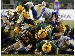 Edmonton Eskimos quarterback Trevor Harris dives for a first down during a Canadian Football League game against the Winnipeg Blue Bombers in Edmonton on Friday, Aug. 23, 2019.