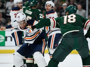 Darnell Nurse (25) of the Edmonton Oilers and Jordan Greenway (18) of the Minnesota Wild throw punches at Xcel Energy Center on Dec. 12, 2019 in St Paul, Mn.