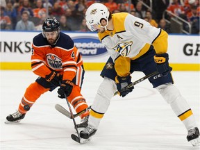 Edmonton Oilers defenceman Kris Russell battles Nashville Predators' Filip Forsberg during second period NHL hockey action at Rogers Place in Edmonton, on Tuesday, Jan. 14, 2020.