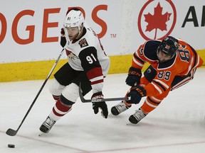 Arizona Coyotes Taylor Hall (left) eludes a check from Edmonton Oilers Sam Gagner during second period NHL hockey game action in Edmonton on Saturday  January 18, 2020.