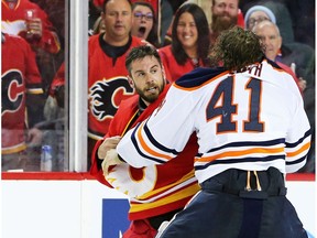 Calgary Flames goalie Cam Talbot and Edmonton Oilers goalie Mike Smith fight in Calgary on Saturday, Feb. 1, 2020.
