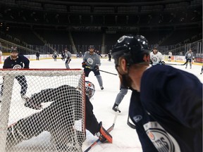 Edmonton Oilers' Zack Kassian (44) runs a drill with teammates on goaltender Mike Smith (41) during a practice on the ice at Rogers Place in Edmonton, on Friday, Feb. 7, 2020. The team plays the Nashville Predators on Saturday.
