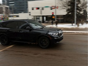 A BMW SUV is driven along 104 Avenue at 100 Street near City Hall in Edmonton, on Thursday, Feb. 13, 2020. City staff have come up with two proposals for speed reductions to make the streets safer for all users that will go before council. Photo by Ian Kucerak/Postmedia