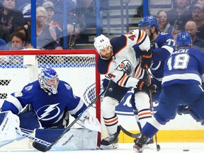 Edmonton Oilers right wing Zack Kassian (44) skates with the puck as Tampa Bay Lightning left wing Ondrej Palat (18) defends and goaltender Andrei Vasilevskiy (88) looks on during the third period at Amalie Arena.