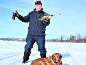 Neil and Penny with a Jackfish Lake walleye. Neil Waugh/Edmonton Sun