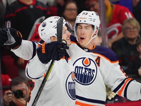 Edmonton Oilers right wing Josh Archibald (15) is congratulated by center Ryan Nugent-Hopkins (93) after his game winning overtime goal against the Carolina Hurricanes at PNC Arena on Sunday, Feb. 16, 2020.
