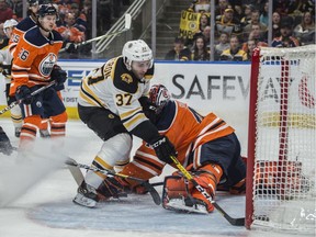 Goaltender Mike Smith (41)of the Edmonton Oilers, is beaten by Patrice Bergeron of the Boston Bruins at Rogers Place in Edmonton on February 19, 2020.   Photo by Shaughn Butts / Postmedia