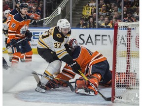 Goaltender Mike Smith (41) of the Edmonton Oilers, is beaten by Patrice Bergeron of the Boston Bruins at Rogers Place on Wednesday, Feb. 19, 2020.