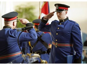 Police Chief Dale McFee, left, and Edmonton Police Service Const. Scott Kramers salute during the graduation ceremony for recruit training class 147 at city hall in Edmonton on Friday, Feb. 21, 2020.