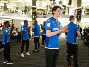Striker Easton Ongaro leads a group of players modeling FC Edmonton's new home jersey during a team event at West Edmonton Mall, on Thursday, Feb. 27, 2020.