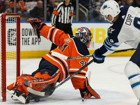 Edmonton Oilers goaltender Mike Smith (41) stops Winnipeg Jets' Andrew Copp (9) during second period NHL hockey action at Rogers Place in Edmonton, on Saturday, Feb. 29, 2020.