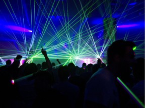 The crowd dances in a laser show at Frequency, a sold-out show at the convention centre on Feb. 19, 2012.