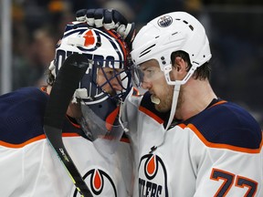 Edmonton Oilers goaltender Mike Smith (41) celebrates with defensceman Oscar Klefbom (77) after defeating the Boston Bruins at TD Garden on Jan. 4, 2020.