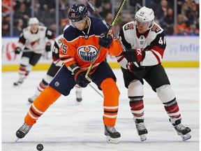 Edmonton Oilers defencemen Darnell Nurse (25) and Arizona Coyotes forward Michael Grabner (40) battle for a loose puck at Rogers Place on Jan. 18, 2020.