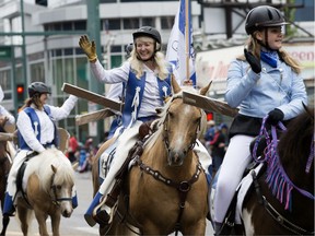 Members of the Alberta Trail Riding Association take part in the K-Days parade through downtown Edmonton, Friday July 19, 2019.