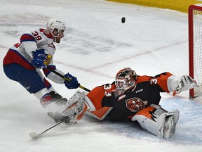 Medicine Hat Tigers goalie Garin Bjorklund (33) makes the save on Edmonton Oil Kings' Ethan McIndoe (39) at Rogers Place on Feb. 15, 2020.