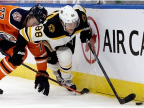 The Edmonton Oilers' Oscar Klefbom (77) battles the Boston Bruins' David Pastrnak (88) at Rogers Place in this file photo from Oct. 18, 2018.