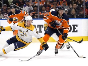 The Edmonton Oilers' Connor McDavid (97) battles the Nashville Predators' Ryan Johansen  (92) during first period NHL action at Rogers Place, in Edmonton Saturday Feb. 8, 2020.