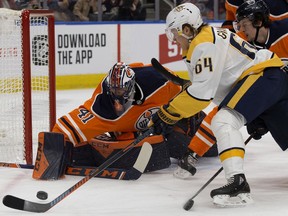 The Edmonton Oilers' goalie Mike Smith (41) and Kailer Yamamoto (56) battles the Nashville Predators' Mikael Granlund (64) during second period NHL action at Rogers Place, in Edmonton Saturday Feb. 8, 2020.