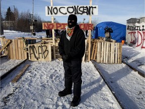A protester who would only give the name Poundmaker at a blockade set up across the CN rail line near 213 Street and 110 Avenue, on Wednesday Feb. 19, 2020.