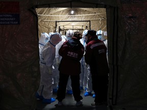 Medical workers in protective suits are seen at the Wuhan Parlor Convention Center, which has been converted into a makeshift hospital following an outbreak of the novel coronavirus, in Wuhan, Hubei province, China Feb. 7, 2020.