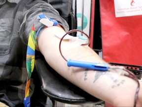A volunteer gives blood at Canadian Blood Services on Wednesday, Jan. 15, 2020. (BRIAN KELLY/POSTMEDIA NETWORK)
