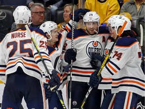 Leon Draisaitl (29) of the Edmonton Oilers is congratulated by teammates Ethan Bear (74), and Darnell Nurse (25) after scoring a hat trick against the Nashville Predators at Bridgestone Arena on March 02, 2020, in Nashville, Tenn.