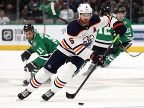 DALLAS, TEXAS - MARCH 03:  Adam Larsson #6 of the Edmonton Oilers skates the puck against the Dallas Stars in the first period at American Airlines Center on March 03, 2020 in Dallas, Texas.