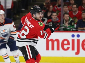 Alex DeBrincat #12 of the Chicago Blackhawks scores his second goal of the game against the Edmonton Oilers at the United Center on March 05, 2020 in Chicago, Illinois.
