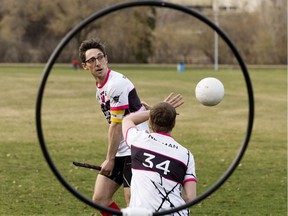Aurors Quidditch Club members Chris Radojewski (left) and James Neuman demonstrate Quidditch in Kinsmen Park on May 4, 2018.