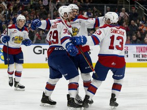 The Edmonton Oil Kings' Dylan Guenther (11) celebrates his goal with Ethan McIndoe (39) and Riley Sawchuk (13) against the Saskatoon Blades at Rogers Place on Jan. 5, 2020.