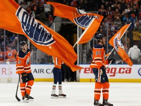 Edmonton Oilers' Josh Archibald (15) and Connor McDavid (97) celebrate the team's 3-2 win over the Winnipeg Jets at Rogers Place on Saturday, Feb. 29, 2020.