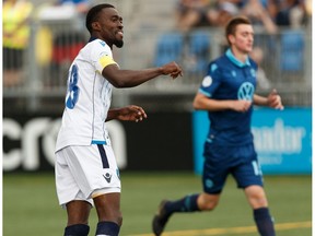 FC Edmonton's Tomi Ameobi (18) scores on HFX Wanderers FC's goalkeeper Christian Oxner (50) on a penalty kick during the second half of a Canadian Premier League soccer game at Clarke Stadium in Edmonton on Wednesday, July 31, 2019.