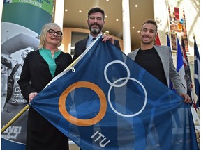 Posing with the ITU flag, from left Sheila O'Kelly, President World Triathlon Edmonton, Mayor Don Iveson and Tyler Mislawchuk, Canadian triathlete, at the 2020 ITU Triathlon Grand Final official kicked-off, for this upcoming summer August 17-23, at City Hall in Edmonton, January 27, 2020.