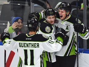 Edmonton Oil Kings Wyatt McLeod (R) celebrates his goal with teammates, Riley Sawchuk (13) and Dylan Guenther (11) against the Spokane Chiefs during WHL action at Rogers Place in Edmonton, March 4, 2020.